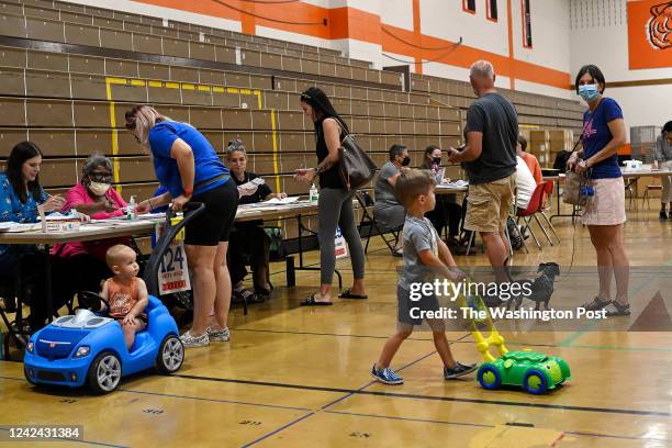 Voters wait in line inside a polling station during the Wisconsin primary Election Day at Riverside University High School on August 9, 2022 in...