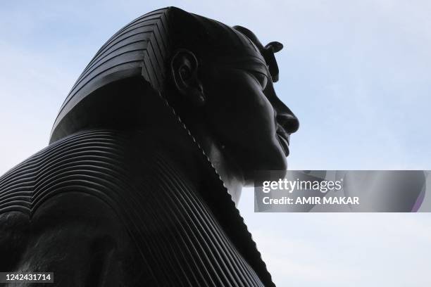This picture taken on August 1, 2022 shows a view of the face of one of the two bronze sphinxes, sculpted in 1878 in the image and bearing the...