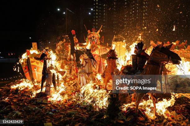 Paper statues of the Chinese deity "Da shi Ye'' and other offerings are burning during the Hungry Ghost Festival at Kota Damansara in Kuala Lumpur....