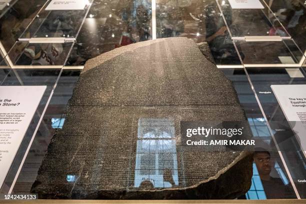 This picture taken on July 26, 2022 shows a view of the Rosetta Stone at the British Museum in London. - The Rosetta Stone a basalt slab dating from...