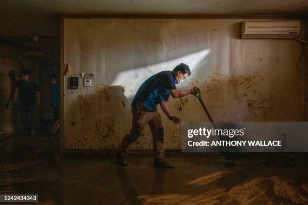 Worker clears a waterlogged, mud-covered basement flat known as "banjiha" in the Gwanak district of Seoul on August 11 after flooding caused by...