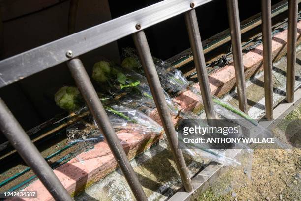 Flowers are left within the bars of an unscrewed security grill for a basement flat known as "banjiha" where three tenants, including a disabled...
