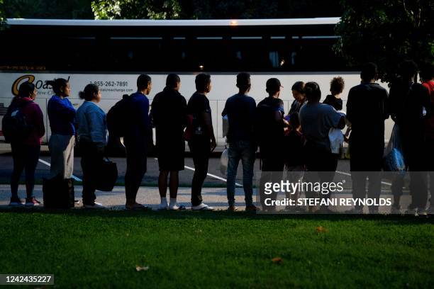 Migrants, who boarded a bus in Texas, listen to volunteers offering assistance after being dropped off within view of the US Capitol building in...