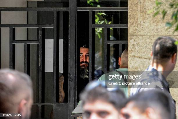August 2022, Lebanon, Beirut: An armed depositor speaks to negotiators from behind the iron bars of a local Bank in Beirut after he stormed the...