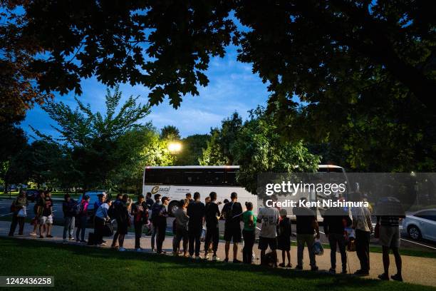 Migrants who traveled from Texas line the sidewalk within view of the U.S. Capitol on Thursday, Aug. 11, 2022 in Washington, DC. Since April, Texas...
