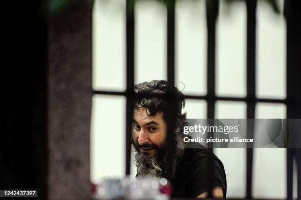 August 2022, Lebanon, Beirut: An armed depositor is seen behind the iron bars of a local Bank in Beirut after he stormed the branch and held...