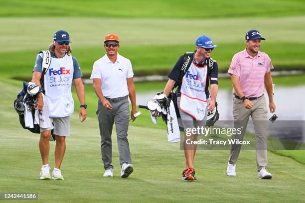 Rickie Fowler walks up the 18th hole with his fill-in caddie, Ben Schomin, Lee Hodges and his caddie, Andrew Medley, during the first round of the...