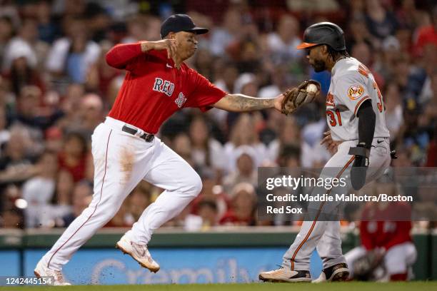 Rafael Devers of the Boston Red Sox tags out Cedric Mullins of the Baltimore Orioles during the sixth inning of a game on August 11, 2022 at Fenway...