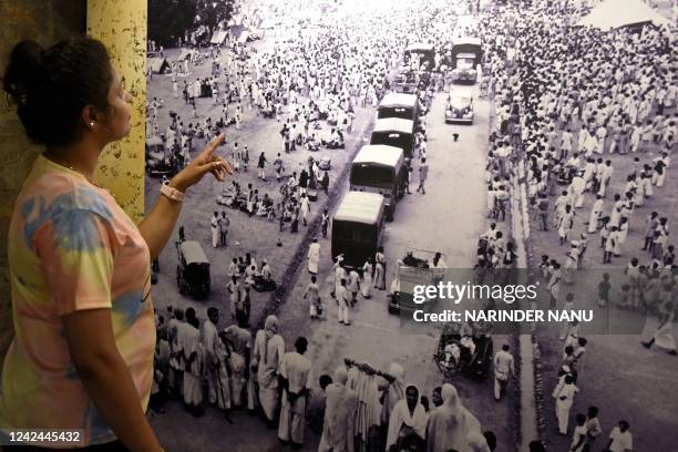 In this photograph taken on August 2 a visitor looks at a picture displayed at the Partition Museum in Amritsar. - India and Pakistan, which...