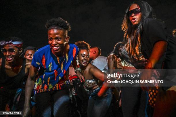 People dance during the Petronio Alvarez Pacific Music Festival in Cali, on August 11, 2022. - The Petronio Alvarez Pacific Music Festival is one of...