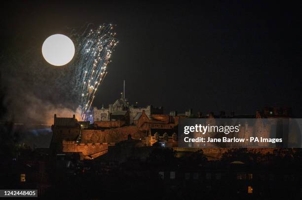 The Sturgeon supermoon, the final supermoon of the year, rises behind Edinburgh Castle during the Royal Edinburgh Military Tattoo firework display....