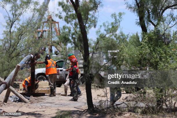 Rescue personnel take part in an operation attempting to reach 10 miners trapped in a flooded coal mine following a landslide a week ago, in Sabinas...