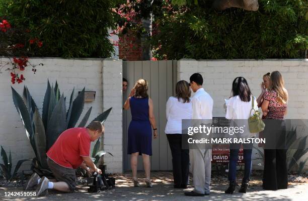 Potential buyers wait outside the former home of actress Marilyn Monroe which was the scene of her death in the Brentwood suburb of Los Angeles on...