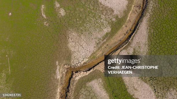 This aerial photograph taken on August 12 shows Bouzey reservoir's drought in Bouzey, eastern France. - The "Lac de Bouzey", an artifical lake...
