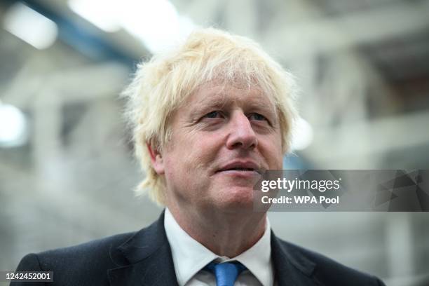 Britain's Prime Minister Boris Johnson reacts as he visits the division manufacturing the wings for the A350 during a tour of the Broughton Airbus...