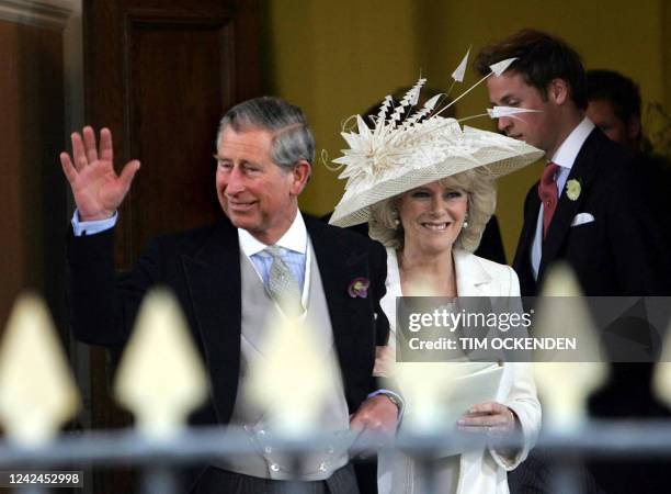 Britain's Prince Charles and new wife Camilla wave to the crowd as they leave the Guildhall in Windsor after their civil wedding ceremony, 09 April...