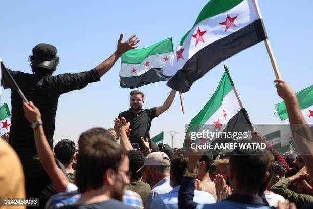 Syrians rally outside a Turkish army position in the opposition-held village of al-Mastumah, about seven kilometres south of the city of Idlib, on...