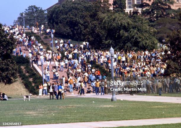 Crowd of people walk on the UCLA campus during a student protest against President Richard Nixon's foreign policies involving the Vietnam war, circa...
