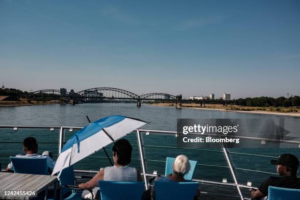 Tourists aboard a cruise boat sail along the River Rhine in Cologne, Germany, on Thursday, Aug. 11, 2022. The Rhine is set to drop well below a...