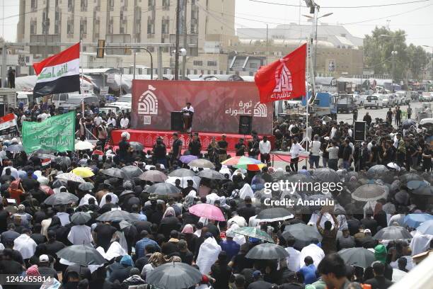 Supporters of Iraqi Shiite cleric Muqtada Sadr take part in Friday prayers outside the parliament building in the Green Zone of the capital Baghdad,...