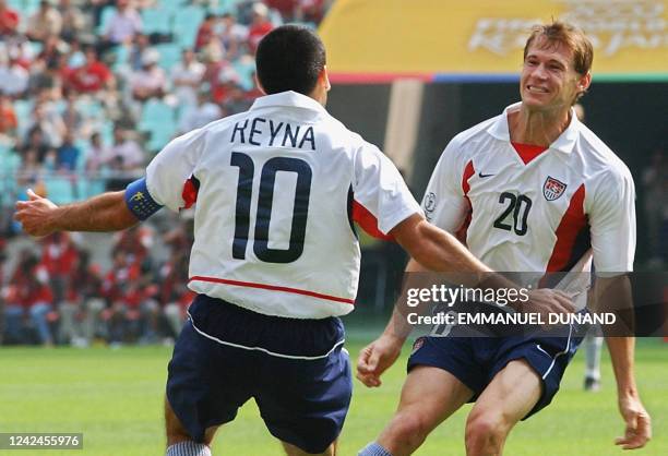 Goalscorer Brian McBride celebrates his 8th minute goal with captain Claudio Reyna, 17 June 2002 at the Jeonju World Cup Stadium in Jeonju, during...