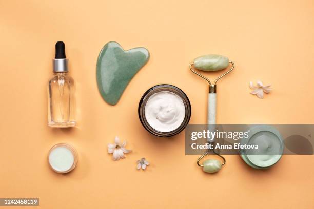 flowers near various spa supplies - cosmetics products stock pictures, royalty-free photos & images