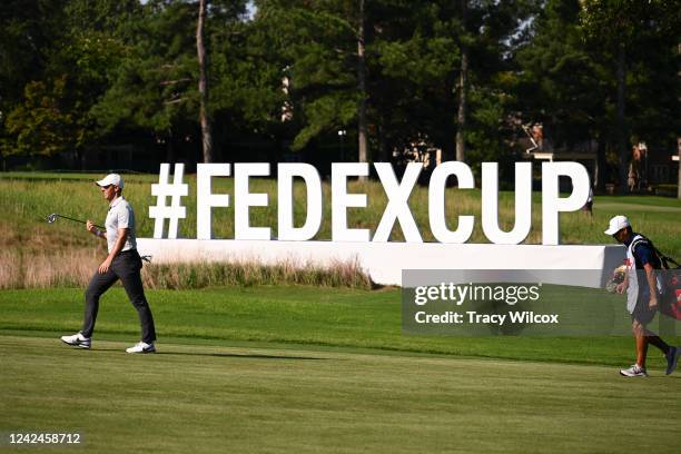 Rory McIlroy of Northern Ireland walks past the #FEDEXCUP signage at the 13th hole during the second round of the FedEx St. Jude Championship at TPC...