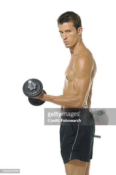 side profile of a young man exercising with a hand weight - musculation des biceps photos et images de collection