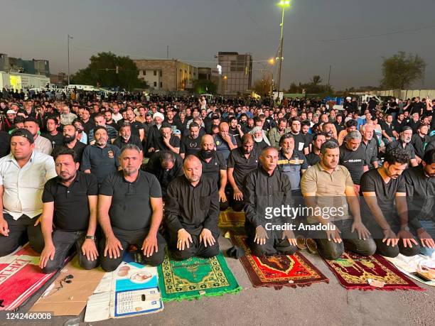 Supporters of Iraqi Shiite cleric Muqtada Sadr take part in prayers outside the parliament building in the Green Zone of the capital Baghdad, as they...
