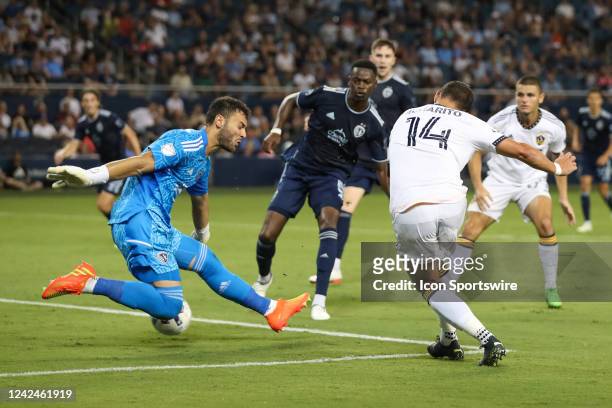 Los Angeles Galaxy forward Javier Hernández gets a shot past Sporting Kansas City goalkeeper John Pulskamp for a goal in the second half of an MLS...