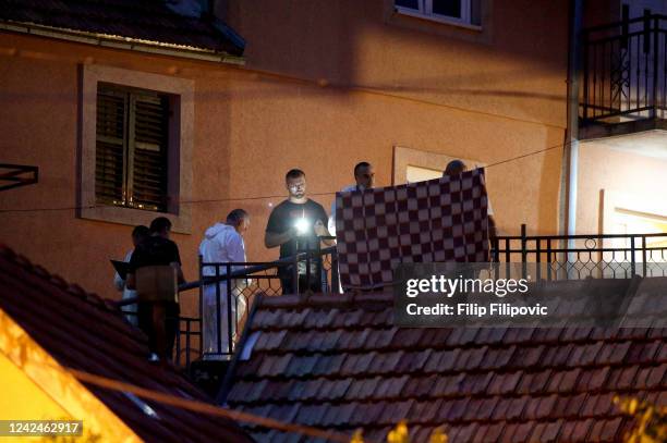 Crime scene investigators inspects a crime scene after a shooting on August 12, 2022 in Cetinje, Montenegro. Twelve people including the gunman have...