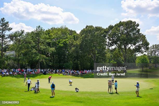 Justin Thomas, Tony Finau and Cameron Young play the seventh green during the second round of the FedEx St. Jude Championship at TPC Southwind on...