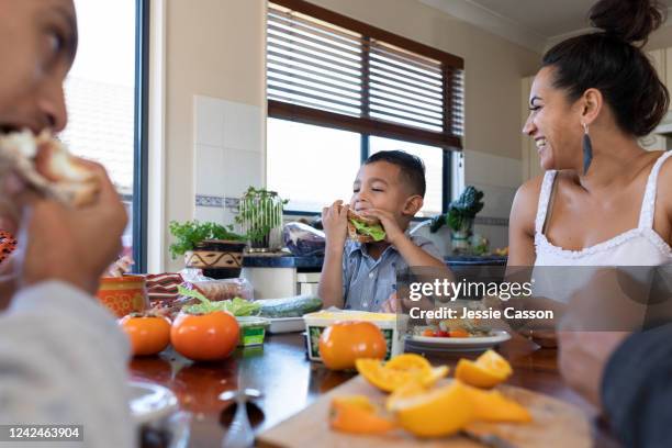 family enjoying lunch around the dining table - auckland food bildbanksfoton och bilder