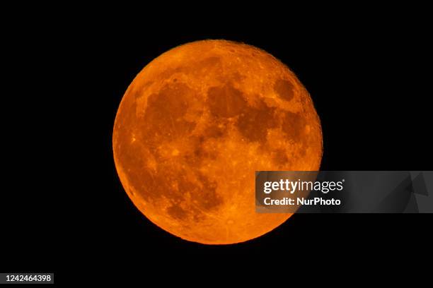 Sturgeon Super Moon rising behind San Bernardino church dome in L'Aquila , on august 12, 2022. August full moon is the last supermoon of 2022.