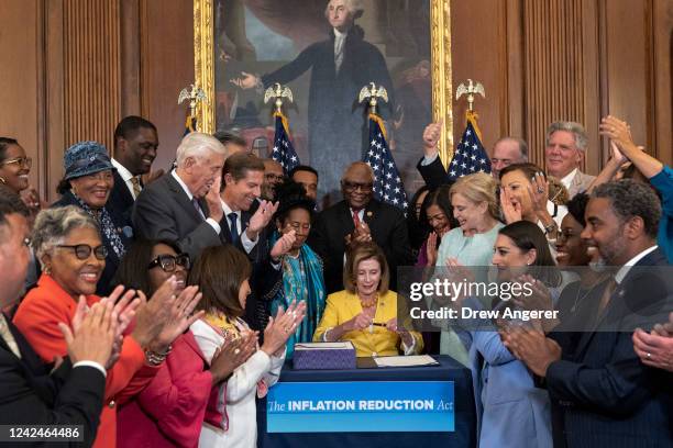 House Democrats applaud after Speaker of the House Nancy Pelosi signed the Inflation Reduction Act during a bill enrollment ceremony after the House...