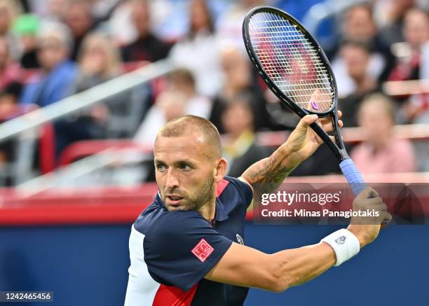 Daniel Evans of Great Britain hits a return against Tommy Paul of the United States during Day 7 of the National Bank Open at Stade IGA on August 12,...