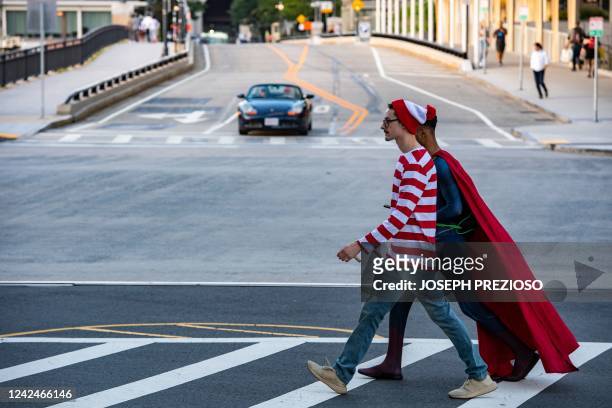 Cosplayers dressed as Wheres Waldo and Superman make their way over a cross walk to the convention center during Fan Expo Boston in Boston on August...