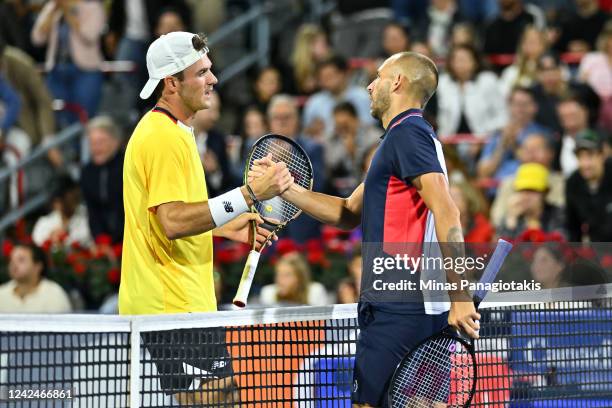 Tommy Paul of the United States congratulates Daniel Evans of Great Britain for his victory during Day 7 of the National Bank Open at Stade IGA on...