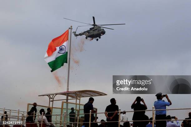 An Indian Air Force helicopter showers flower petals during full dress rehearsals of Independence Day celebrations at the historic Red fort in New...