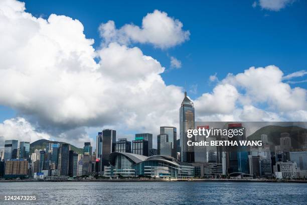 General view shows commercial and residential buildings next to Victoria Harbour in Hong Kong on August 13, 2022.