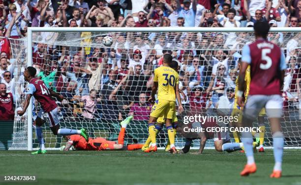 Aston Villa's English striker Danny Ings reacts after scoring the team's first goal during the English Premier League football match between Aston...