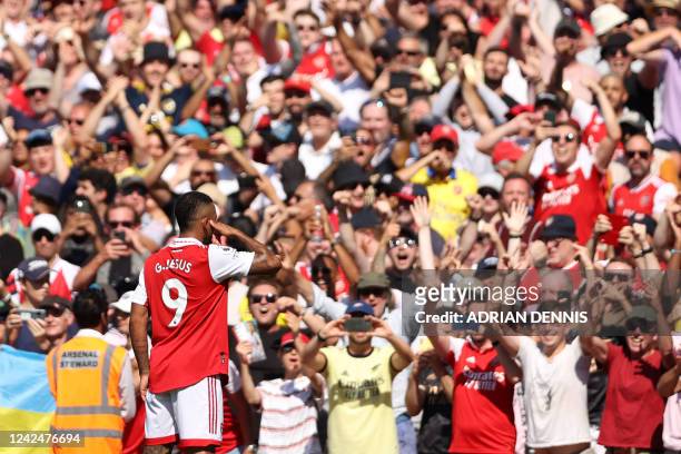 Arsenal's Brazilian striker Gabriel Jesus celebrates in front of supporters after scoring the opening goal of the English Premier League football...