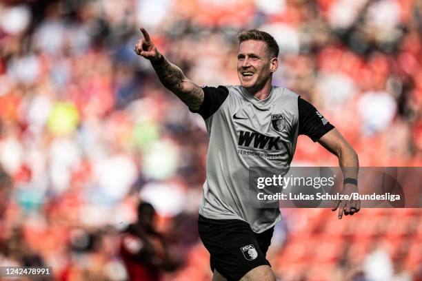 Scorer Andre Hahn of Augsburg celebrates his teams second goal during the Bundesliga match between Bayer 04 Leverkusen and FC Augsburg at BayArena on...