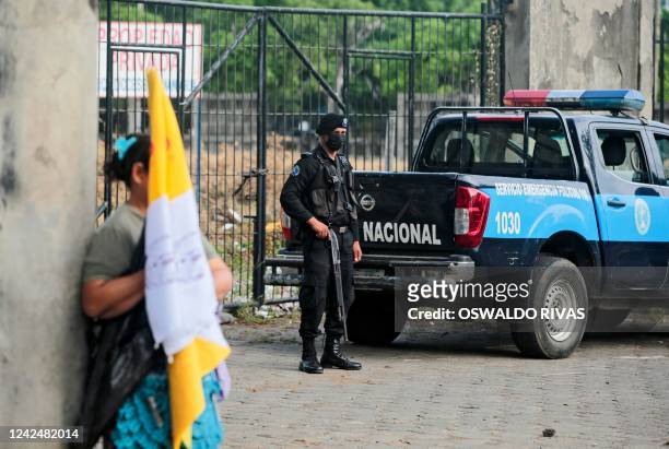 National Police officer stands guard at one of the main entrances to the Cathedral during a procession of the Virgin of Fatima within the grounds of...