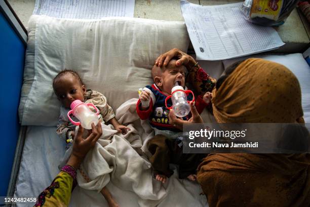 Babies on a children’s ward at Indira Gandhi hospital receive treatment for malnutrition on August 13, 2022 in Kabul, Afghanistan. The collapse of...