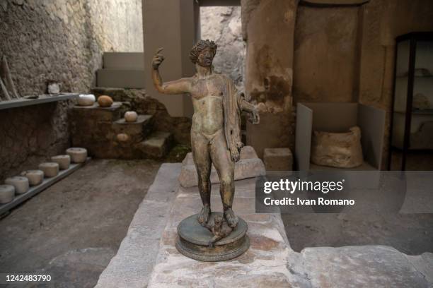 Bronze statue inside a deposit in the ancient Roman city of Herculaneum destroyed in 79 AD by the eruption of Vesuvius which also affected Pompeii,...