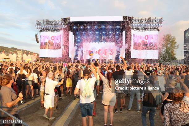 August 2022, Thuringia, Saalburg-Ebersdorf: Party guests celebrate and dance at the Bleilochtalsperre at the "SonneMondSterne" festival. It is one of...