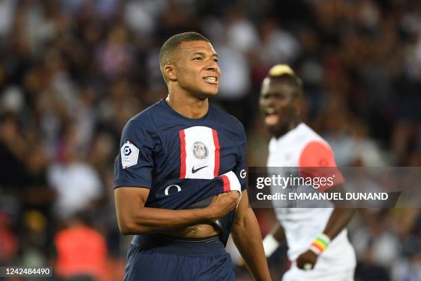 Paris Saint-Germain's French forward Kylian Mbappe reacts after missing to score on a penalty kick during the French L1 football match between...