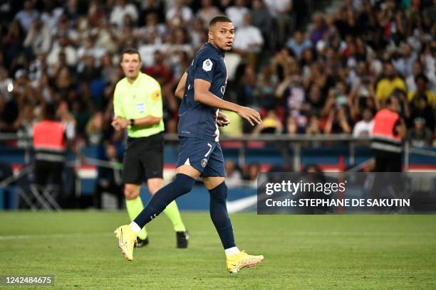 Paris Saint-Germain's French forward Kylian Mbappe reacts after missing to score on a penalty kick during the French L1 football match between...