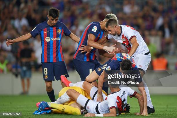 Stole Dimitrievski Goalkeeper of Rayo Vallecano and North Macedonia and Robert Lewandowski of Barcelona compete for the ball during the La Liga...